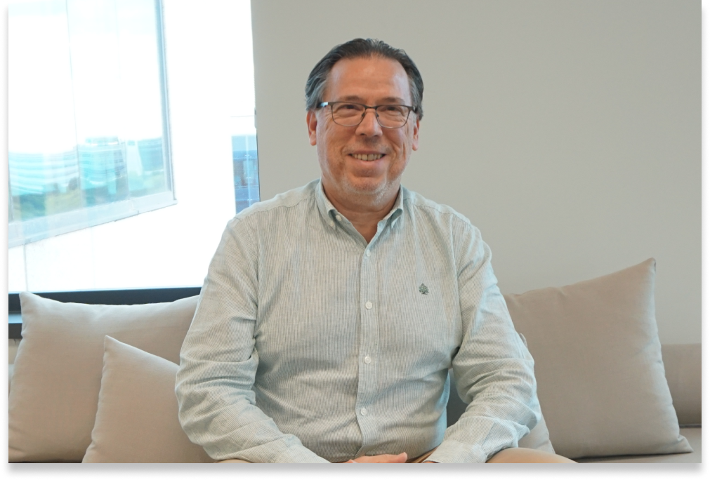 An image of a man smiling at the camera.